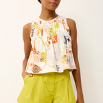 woman in printed top and green shorts 