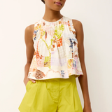 woman in printed top and green shorts 