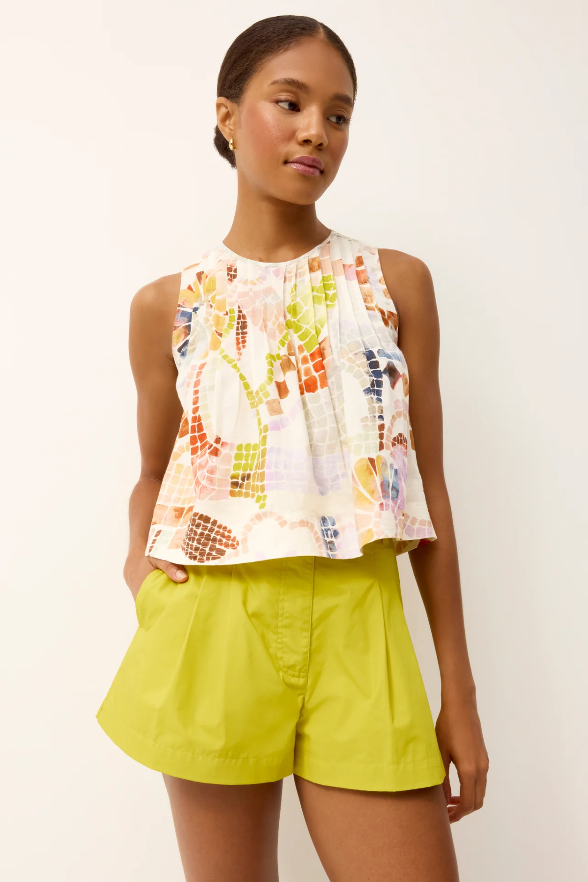 woman in printed top and green shorts 