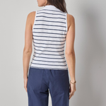 Woman wearing a striped sleeveless top and blue pants against a plain background