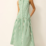 Woman wearing a green and white striped dress on a plain background